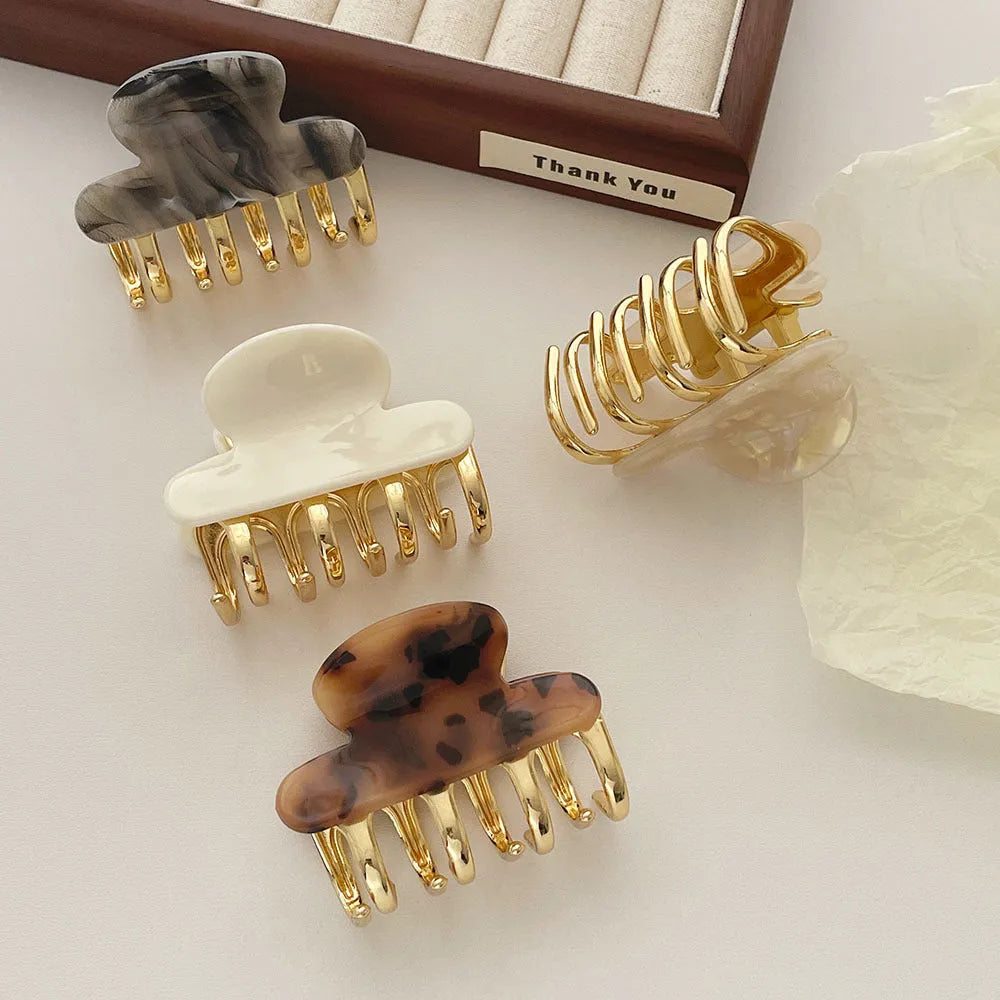 Acetate hair barrettes with metal grip closure in leopard print, beige, white and ink colours
