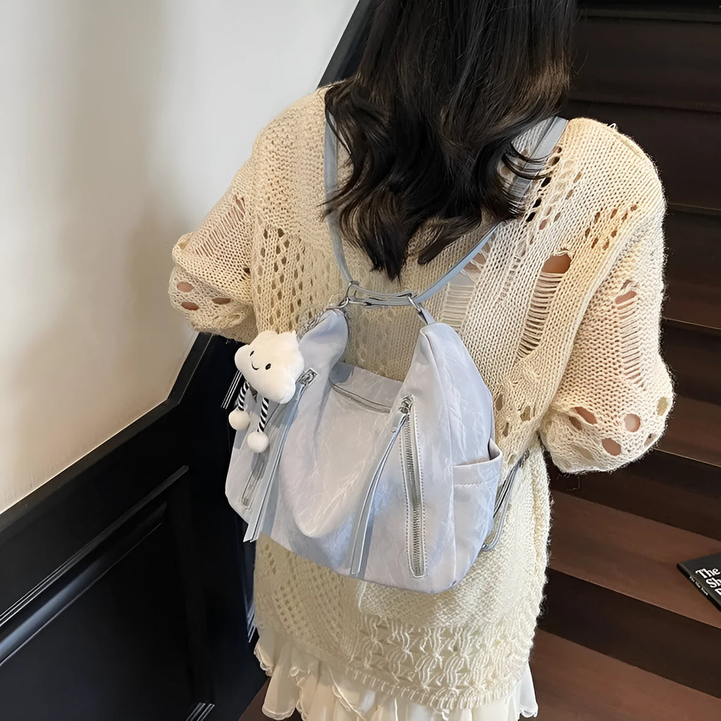Women's soft PU fashion backpack in multiple colours showing backpack and shoulder bag carrying options with pendant accessory