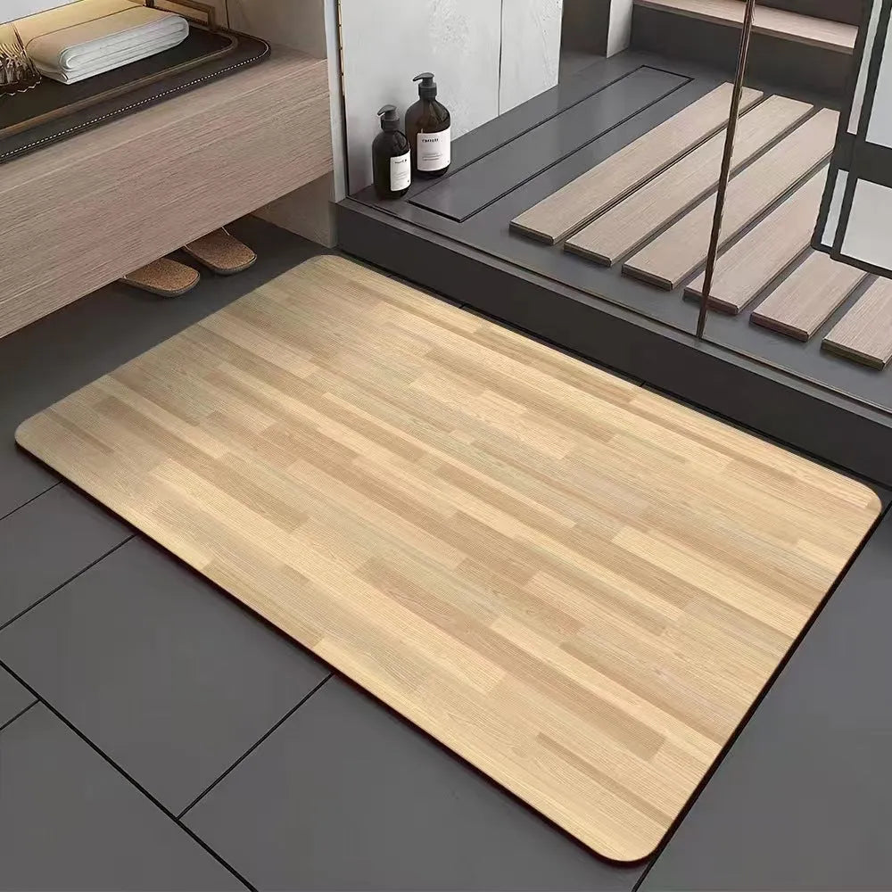 Square diatomite bathroom mat with wood grain pattern on a bathroom floor.