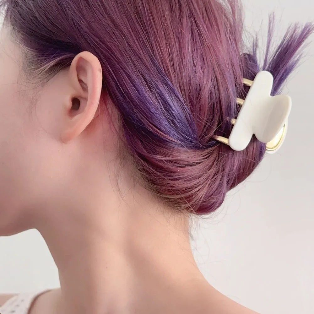 Acetate hair barrettes with metal grip closure in leopard print, beige, white and ink colours