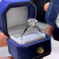 Six-claw zircon ring with geometric design and white gold plated finish shown on finger