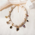 Close-up of a women's resin necklace with a heart-shaped pendant containing a bamboo detail and an electroplated metallic finish.