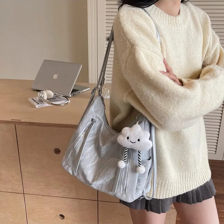Women's soft PU fashion backpack in multiple colours showing backpack and shoulder bag carrying options with pendant accessory