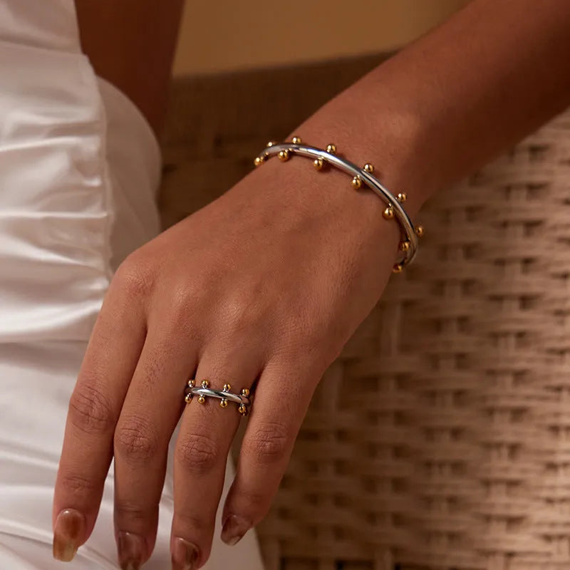 Stainless steel C-shaped bean bead bracelet with textured rivet detailing and alloy chain in three colour options