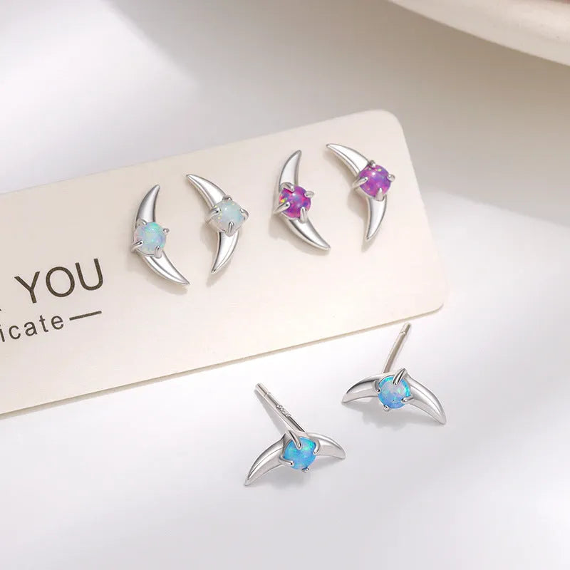 Women's 925 silver geometric earrings with electroplated finish and blue crystal stone.