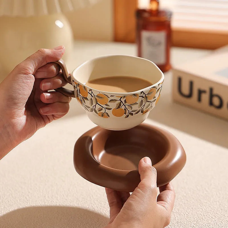 Antique style ceramic coffee cup and saucer with 210ml capacity in black pomegranate or orange citrus pattern.