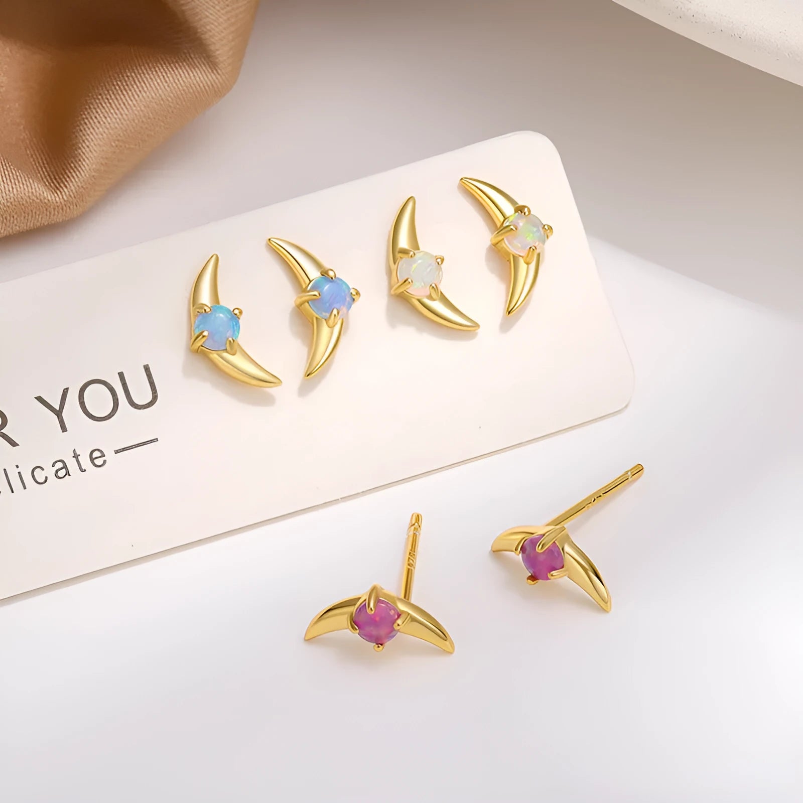 Women's 925 silver geometric earrings with electroplated finish and blue crystal stone.