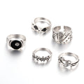 Black alloy fashion ring with a raised retro poker card spade design on a finger.