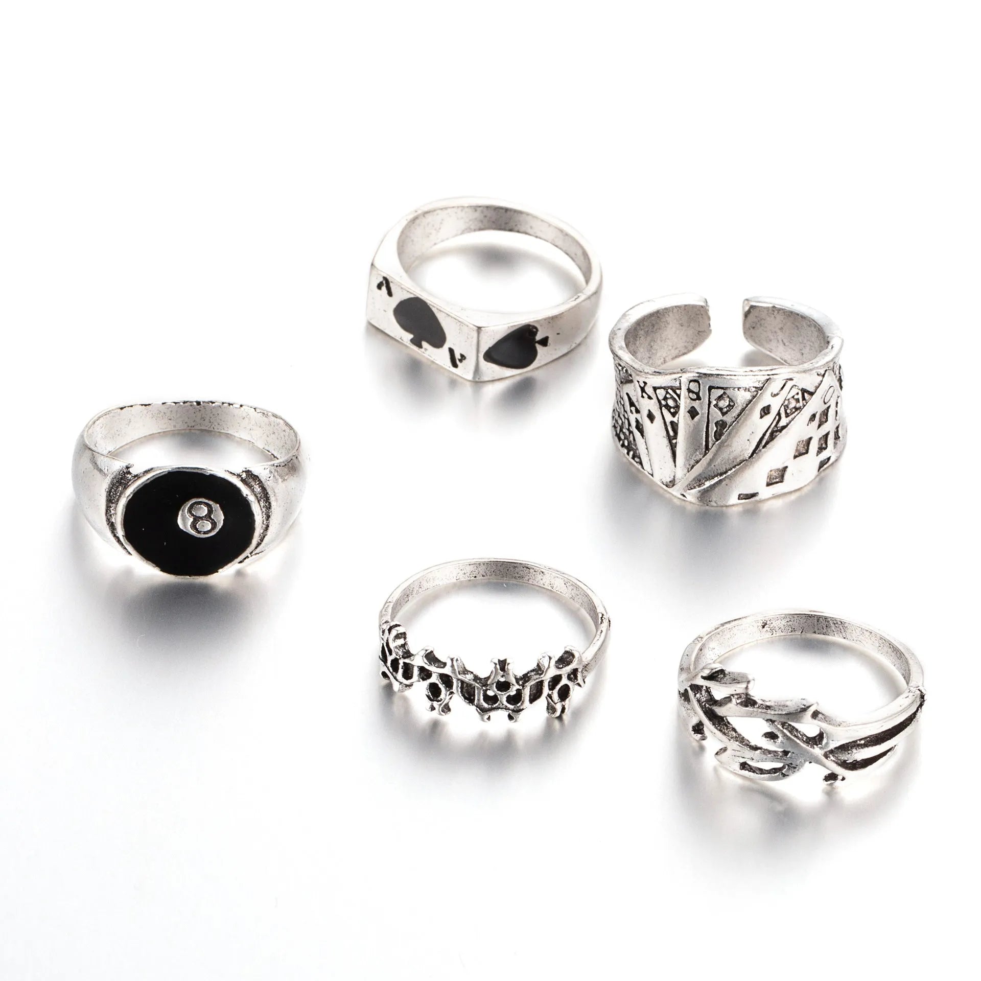 Black alloy fashion ring with a raised retro poker card spade design on a finger.