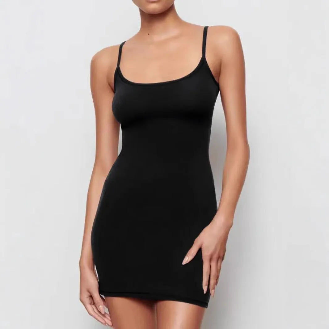 Black slim fit sleeveless sling sheath dress on a model, showing short skirt and mid-waist.