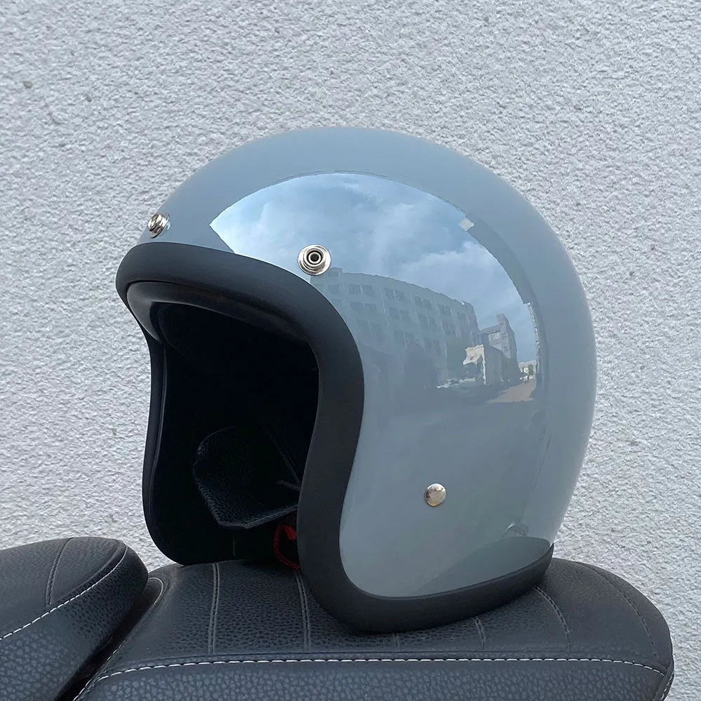 Retro-style half motorcycle helmet in fibreglass, shown in a cement grey colour option.