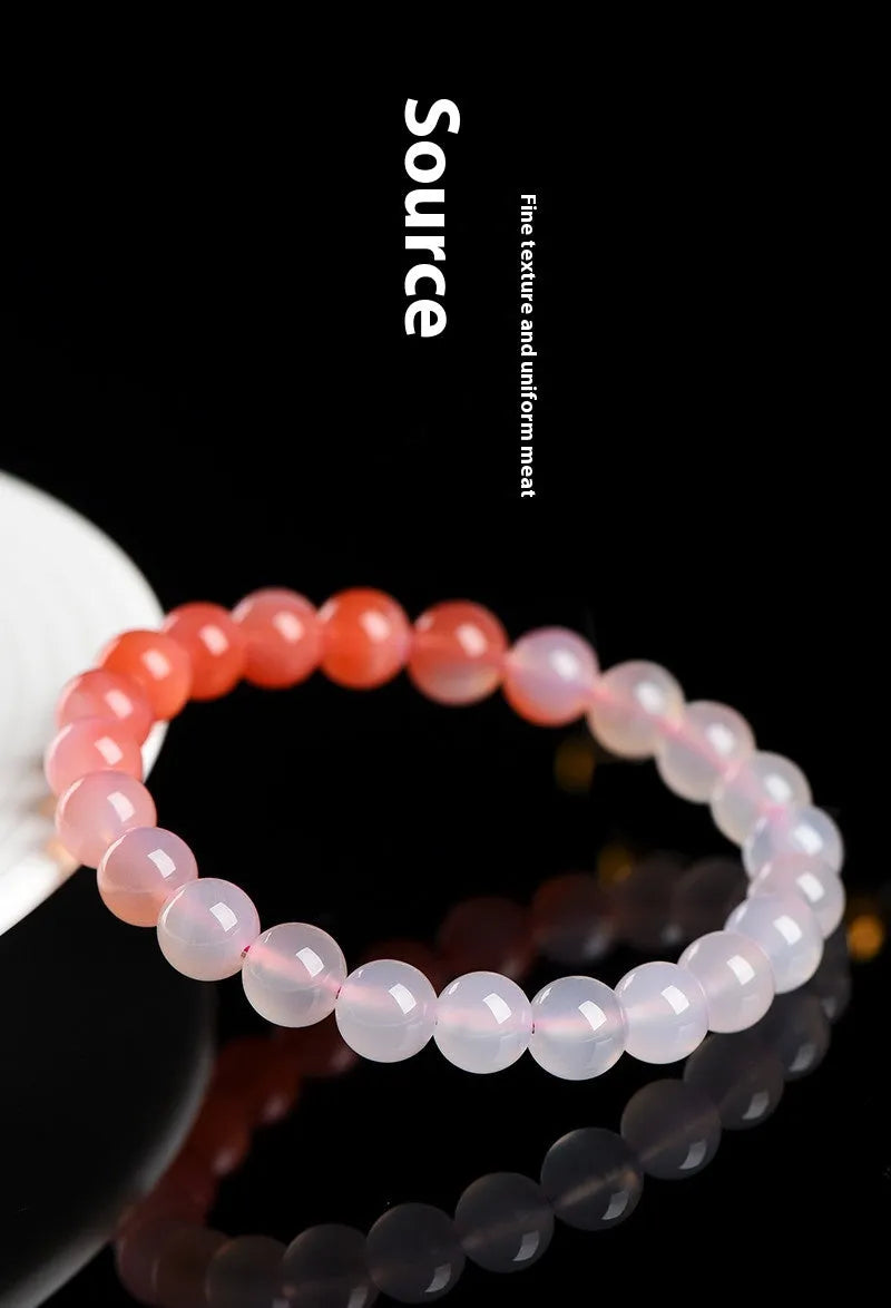Natural gradient Yanyuan agate bracelet with geometry-shaped beads on a wrist.