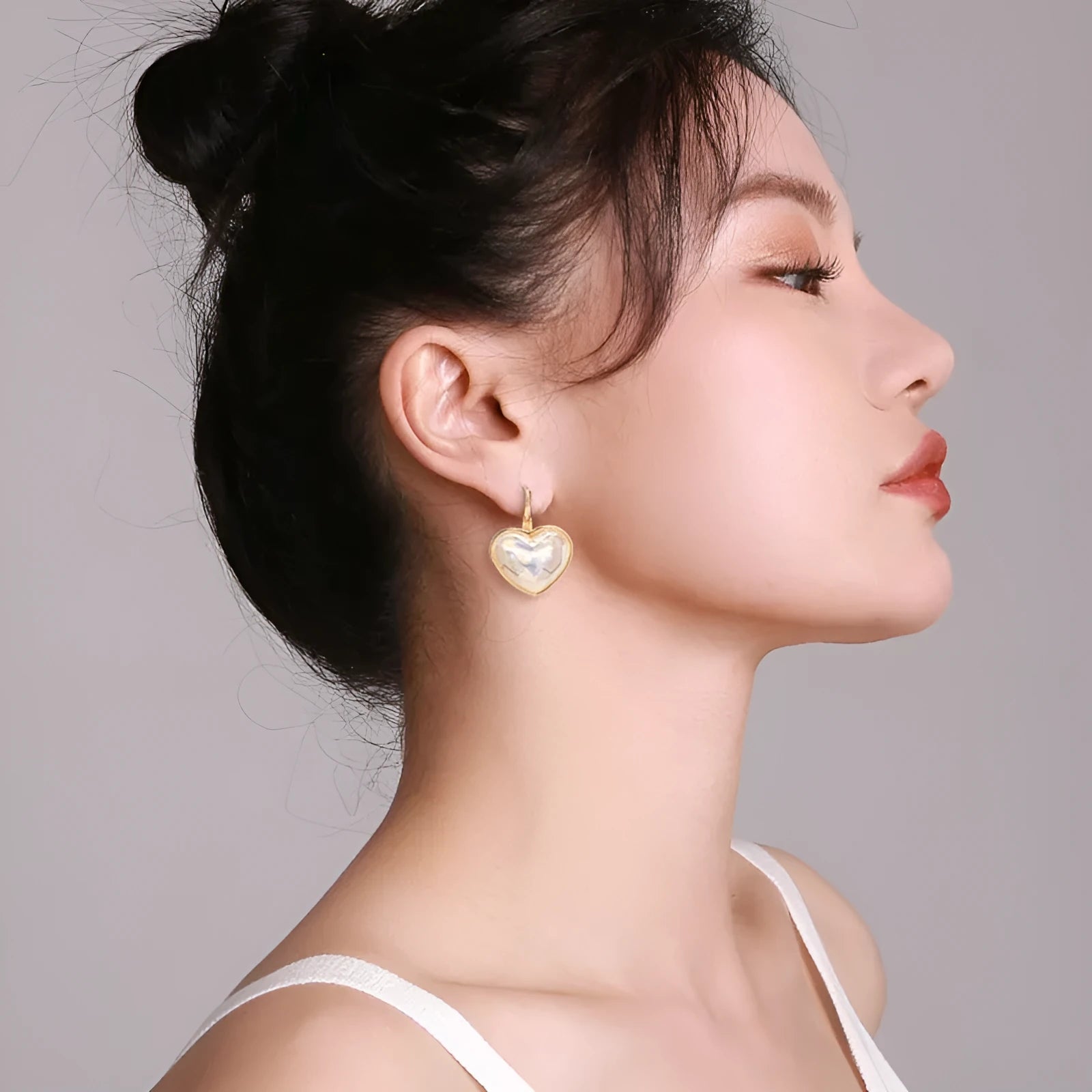 Gold women's ear clip with summer love design and clip-on fastening