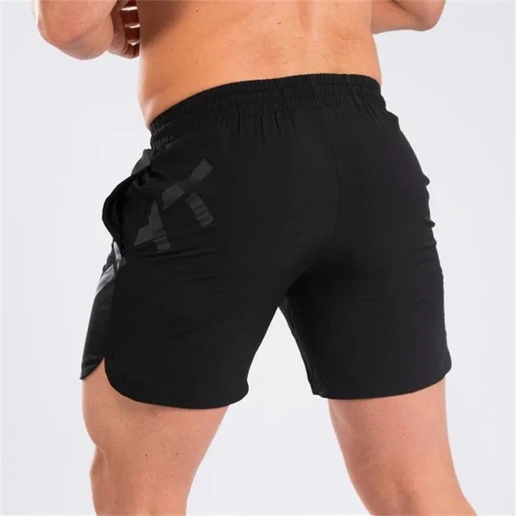 Men's black elastic running shorts with a mid-waist and knee-length cut on a plain background.
