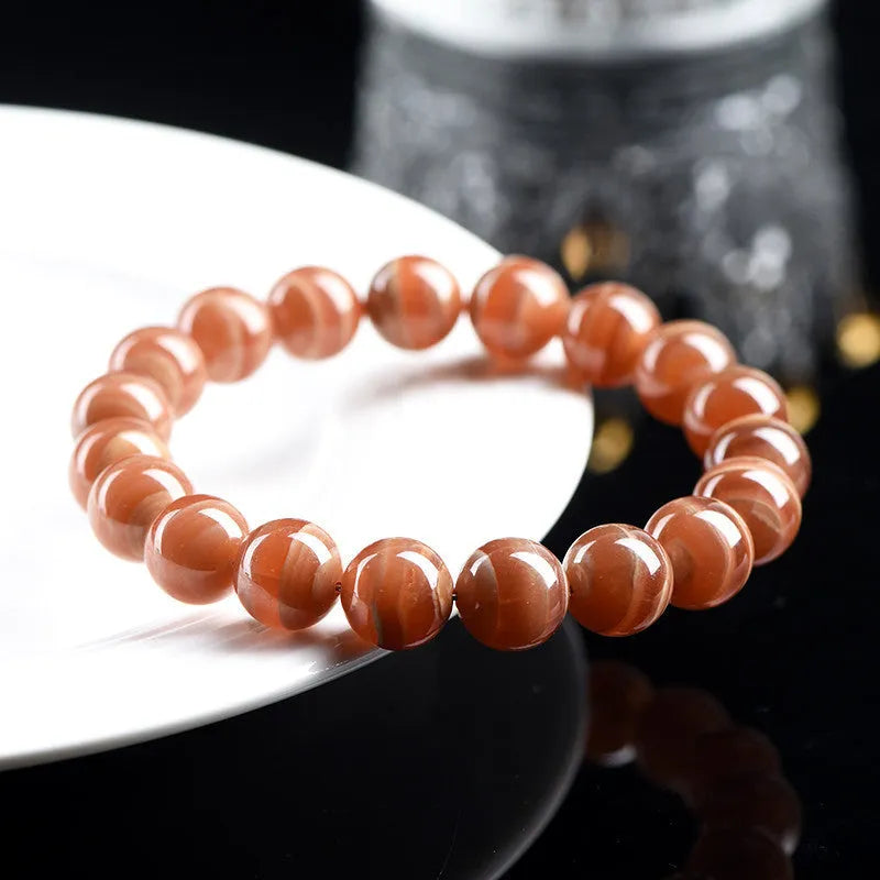 Natural old mine rhodochrosite round bead bracelet with geometric design and Ruyi elements.