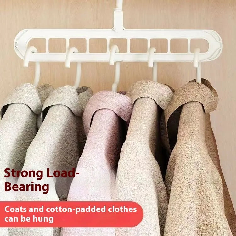 Green plastic folding clothes hanger with nine holes for organising trousers on a rack.