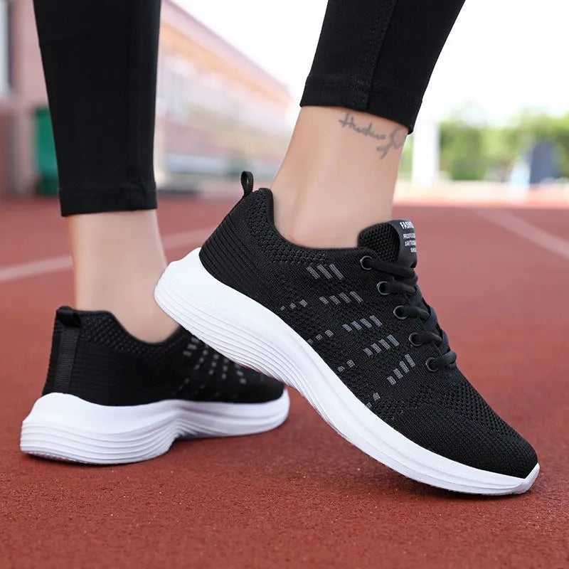 Women's black mesh breathable non-slip sneaker with lace-up front and flat heel, side view