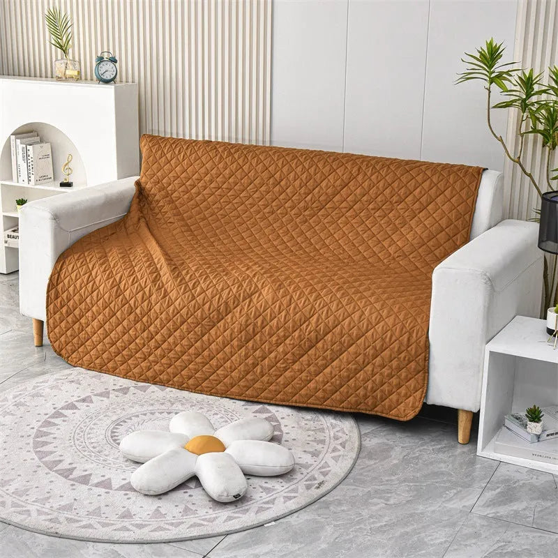 Reversible dog blanket sofa cover in grey and cream colours laid flat on a sofa