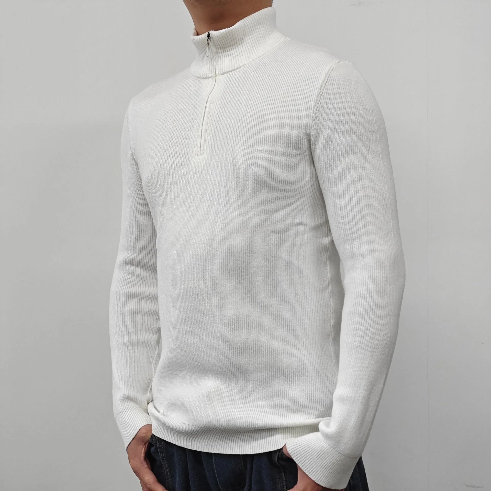 Man wearing a grey half turtleneck zipper sweater, a British style cotton blend pullover for spring.