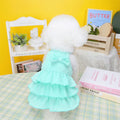 Small dog wearing rose red princess dress with layered skirt candy theme