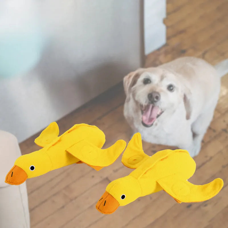 Yellow plush teddy dog toy with internal squeaky duck for training and food leak feature