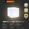 Modern white LED cube stool light outdoors, showing flat top and clean design.