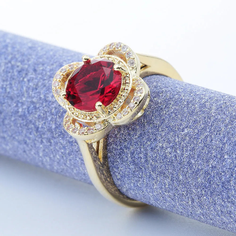 Copper ring with a zircon stone inlay in a fruit shape design on a finger.