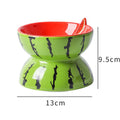 Ceramic raised cat bowl with tilted design in orange pattern, showing elevated feeding position