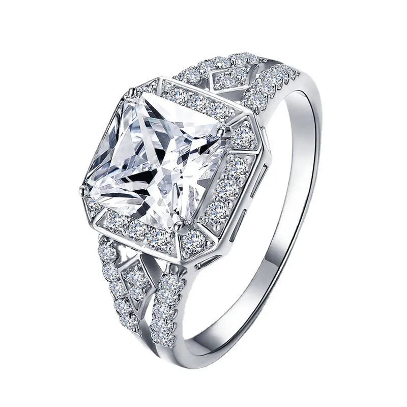 Geometric hollow zircon ring in platinum colour with four-sided design on woman's finger