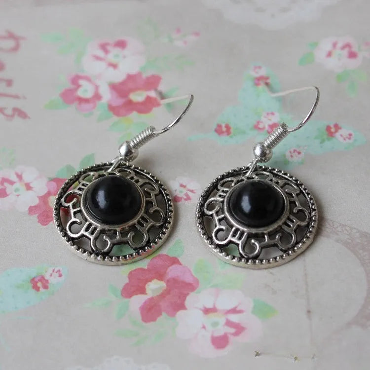 Miao ethnic silver earrings with geometric flower disk design and turquoise accents