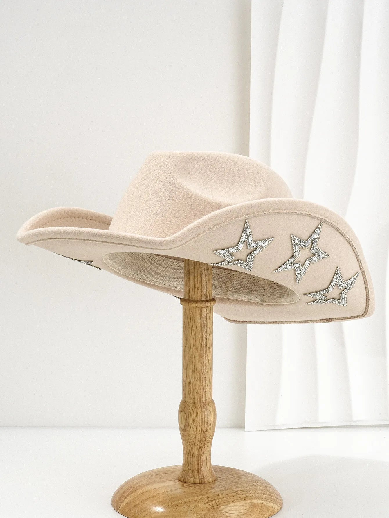 Beige polyester western denim top hat with a conical crown and a silver hexagonal star decoration on the front.