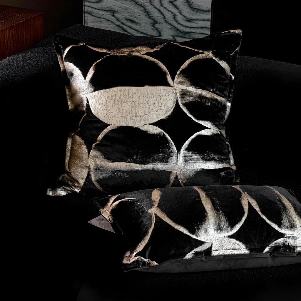 Black gold abstract pattern flannel cushion pillow in square and rectangular sizes on a sofa.