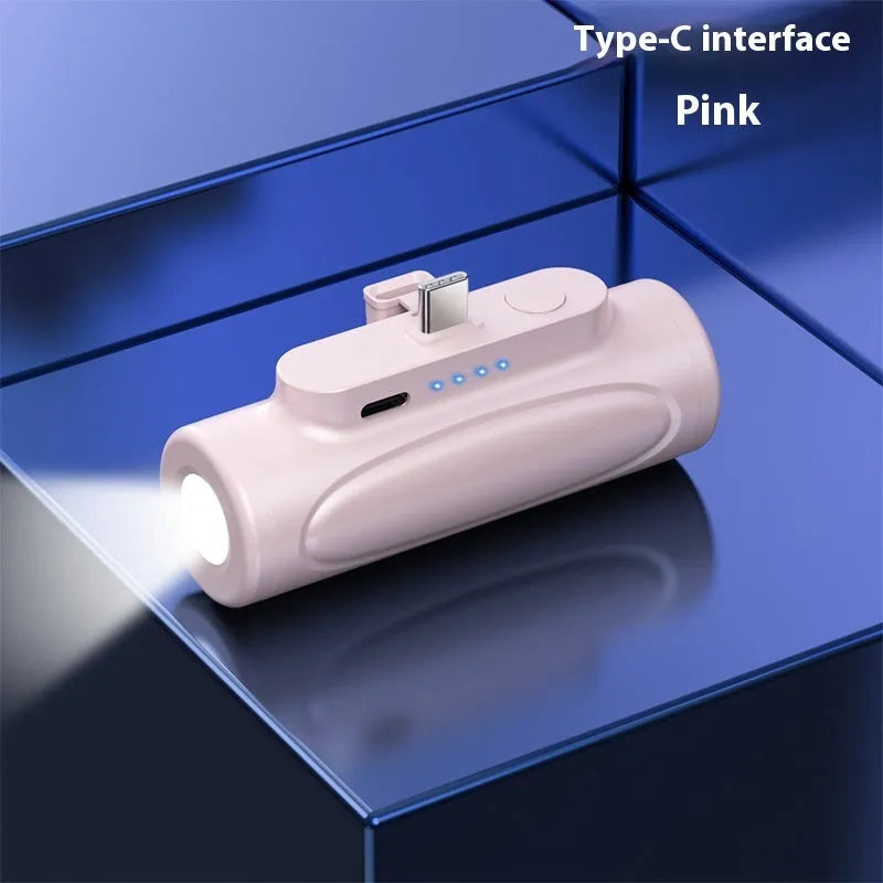 Black and pink creative power bank with integrated LED flashlight, showing Type-C and Apple port options.