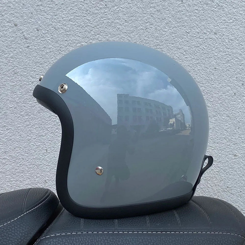 Retro-style half motorcycle helmet in fibreglass, shown in a cement grey colour option.