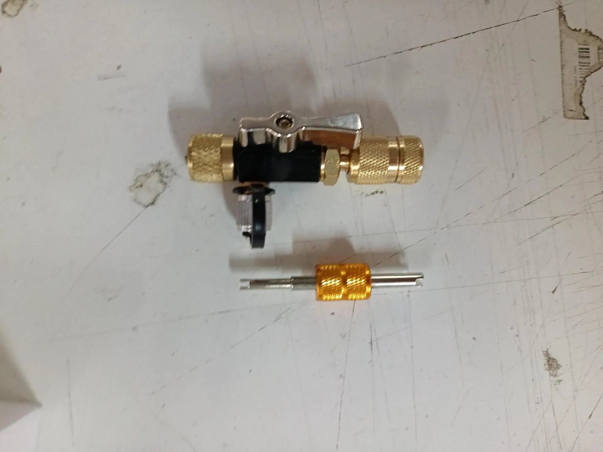 Metal vacuum valve core disassembly tool set showing black and pink colour variations