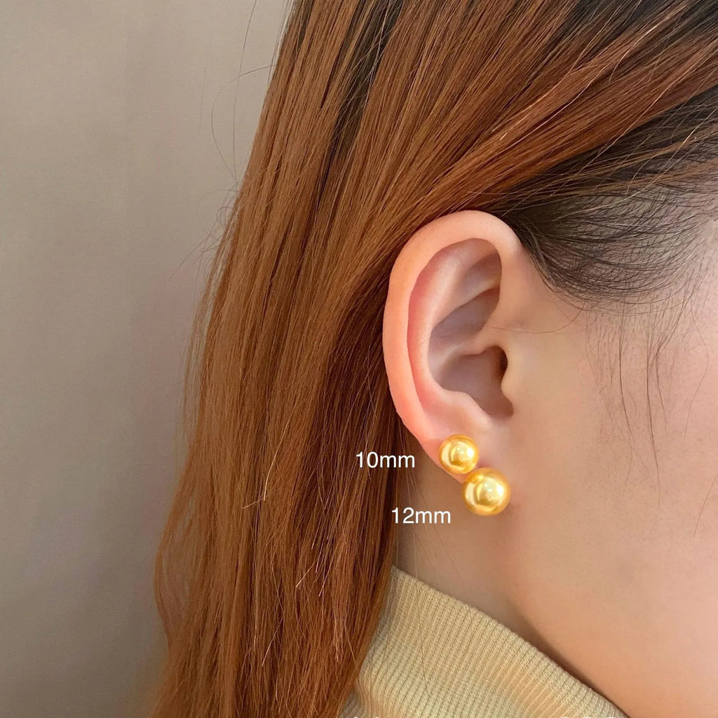Geometric pearl stud earrings with retro styling in silver with eight-point star details