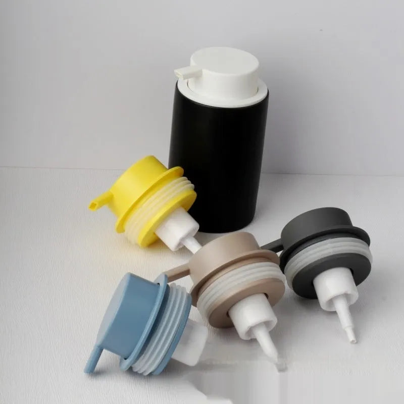 Facial cleanser foam pump with large plastic head in various metallic finish options.
