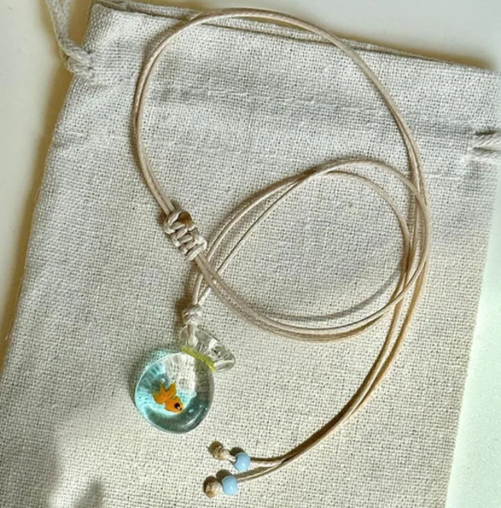 Women's necklace with a coloured glaze Small Fish Lucky Bag pendant on a cotton and linen clavicle chain.