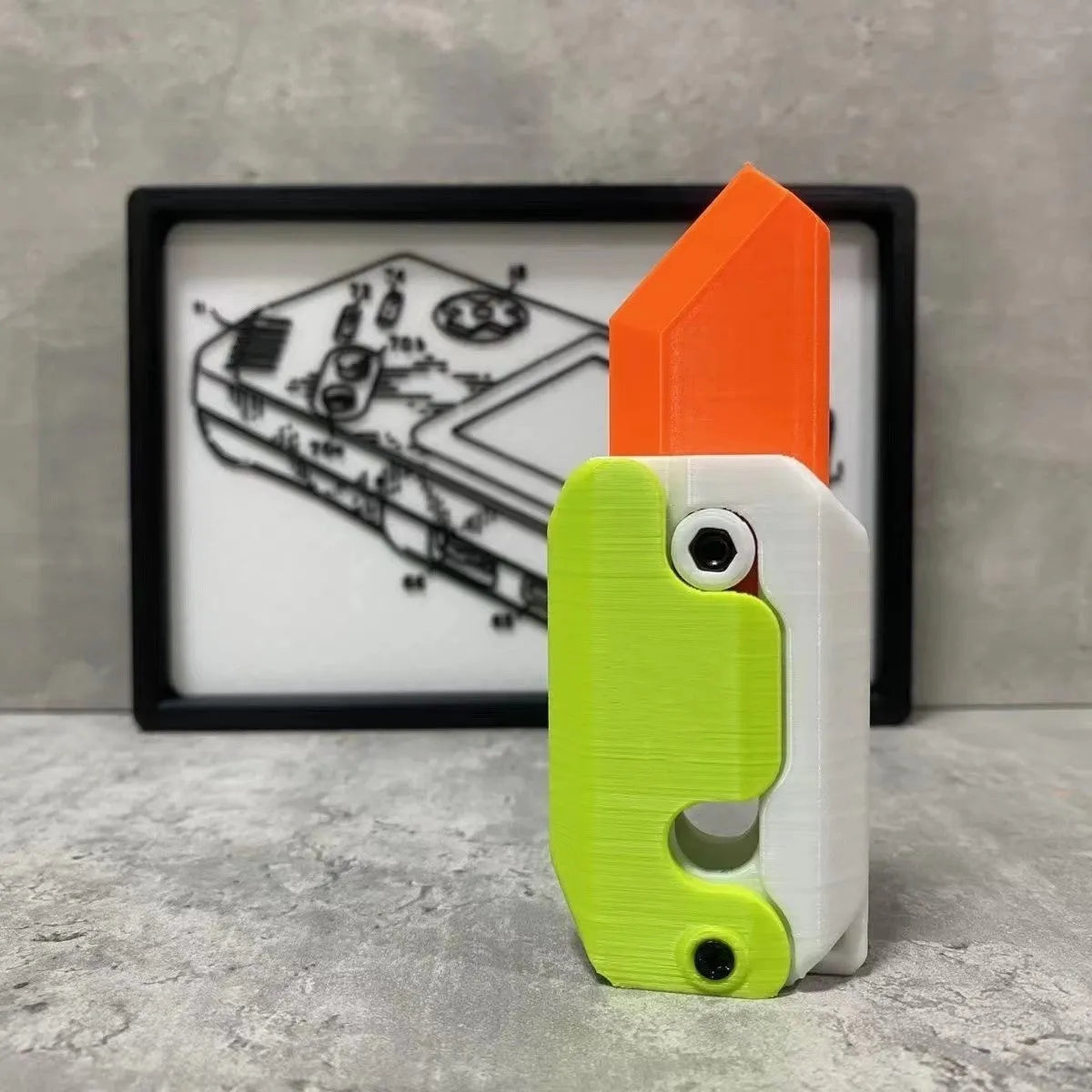 Carrot-shaped 3D printed plastic gravity fidget knife with orange purple green colour scheme