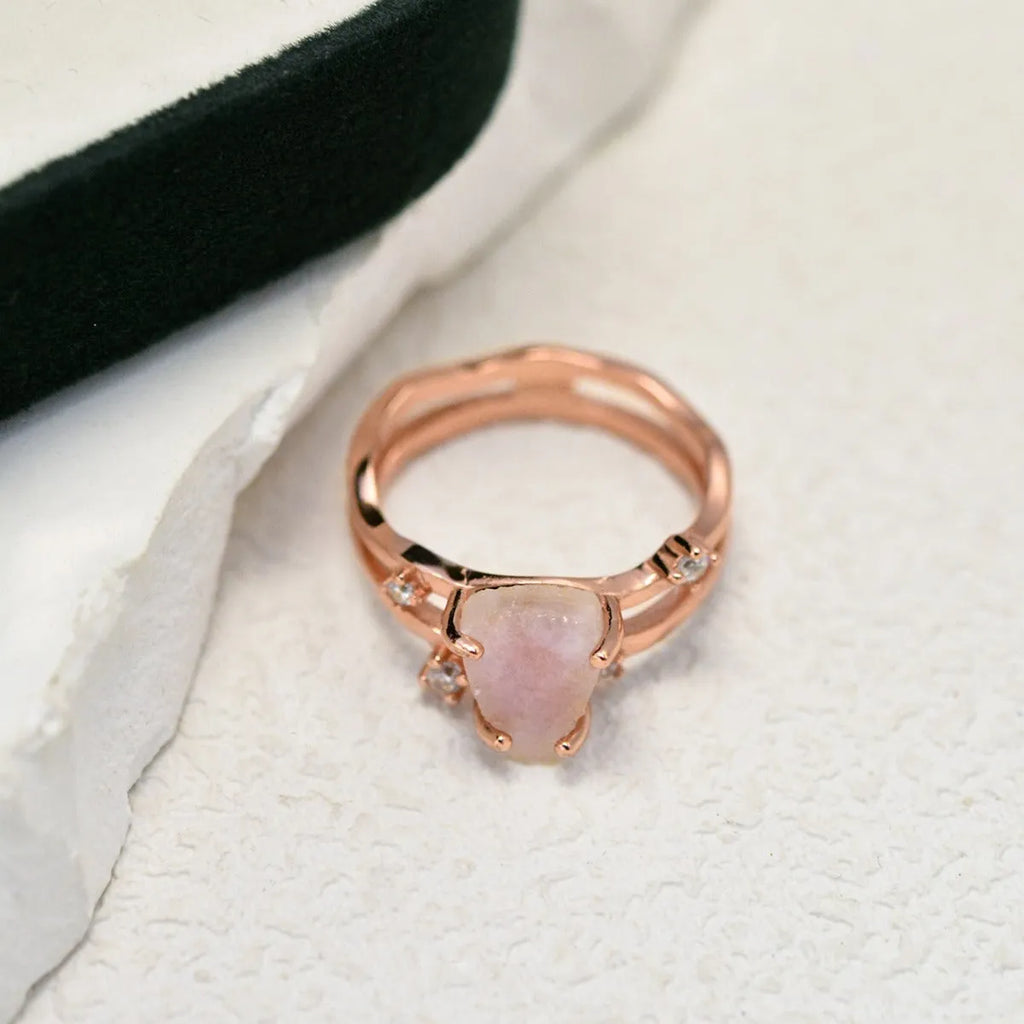 S925 sterling silver ring with irregular triangle shape holding a moonstone, shown in rose gold electroplated finish.
