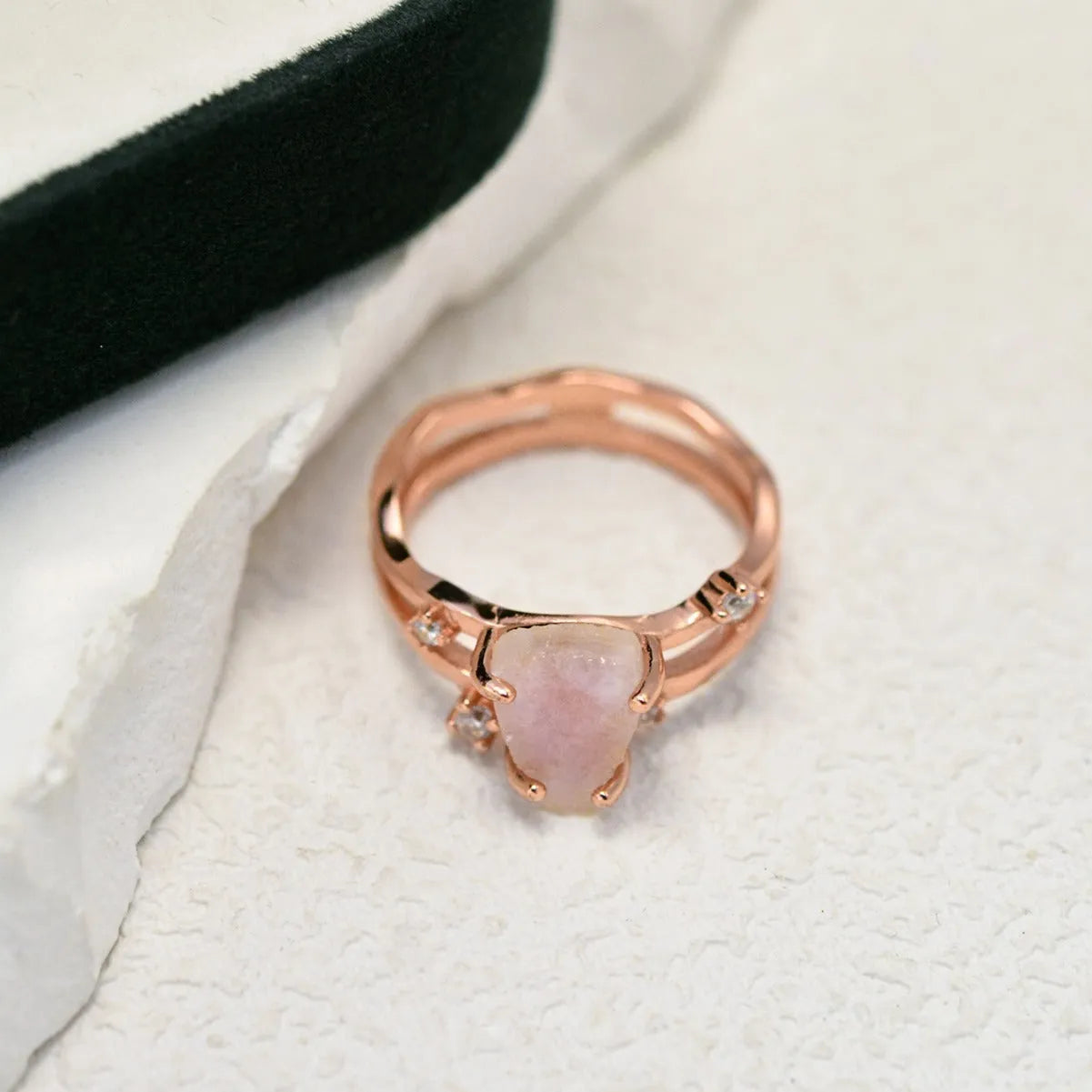 S925 sterling silver ring with irregular triangle shape holding a moonstone, shown in rose gold electroplated finish.
