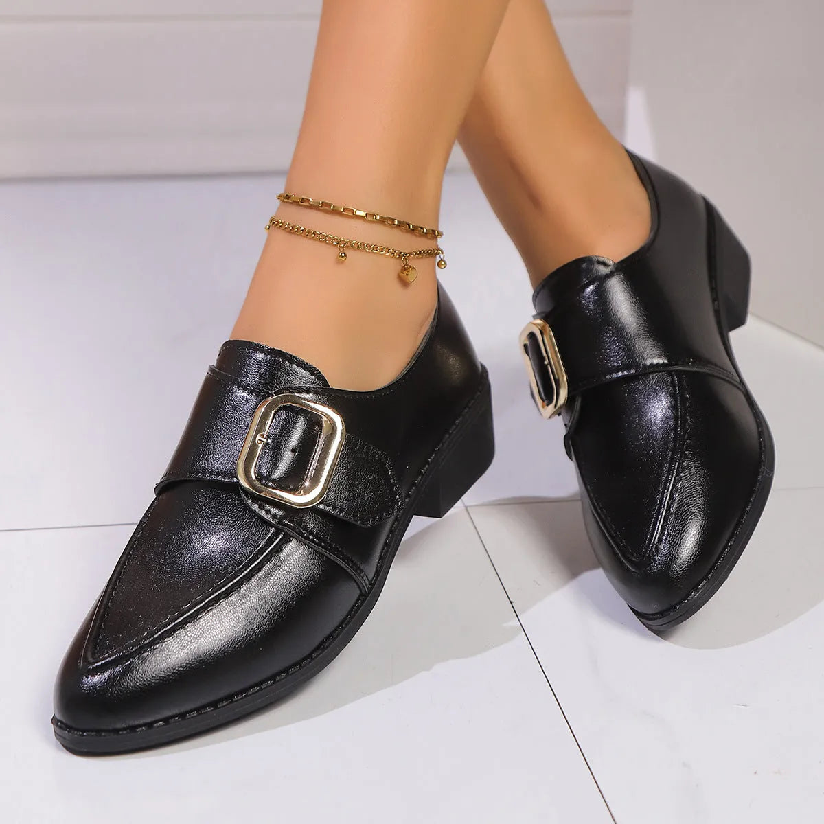 Women's brown slip-on flat shoes with a large bow decoration on the pointed toe.