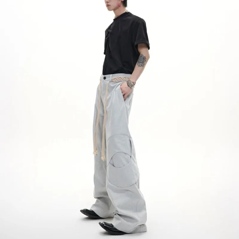Men's dark wash straight-leg jeans with 3D cutting, zip decorations, and tassel details