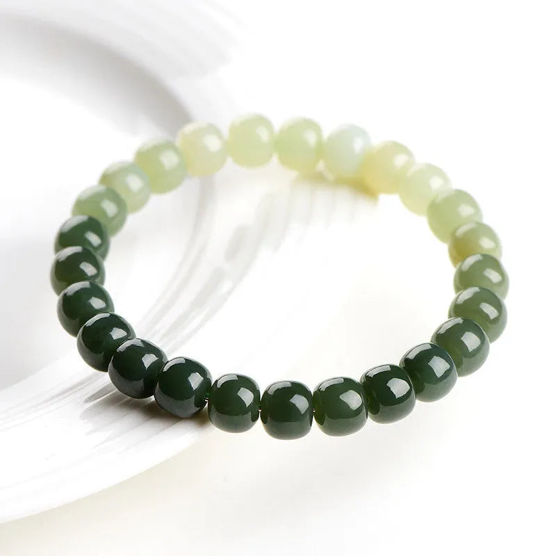 Natural Hetian jade bracelet showing water gradient colour variation on polished surface