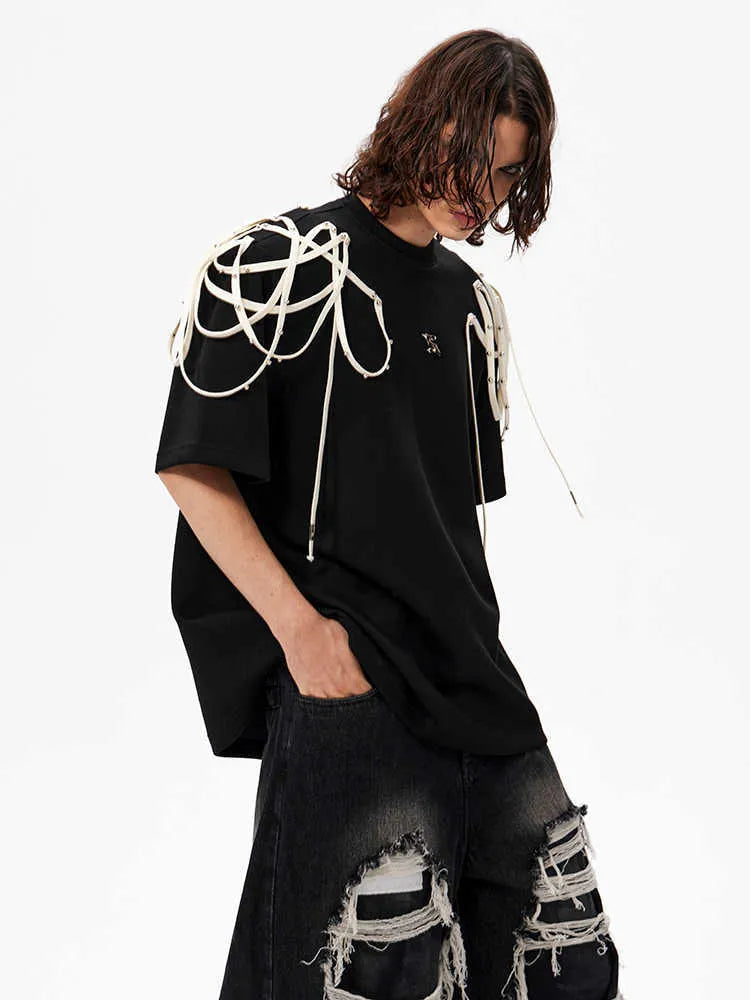 Black loose fit T-shirt with padded shoulders featuring rivet ribbon decoration and short sleeves