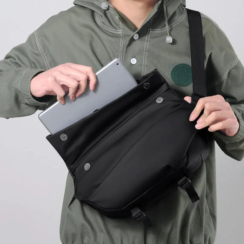 Grey PU leather men's crossbody bag with a shoulder strap, shown with open compartment for phone and documents.