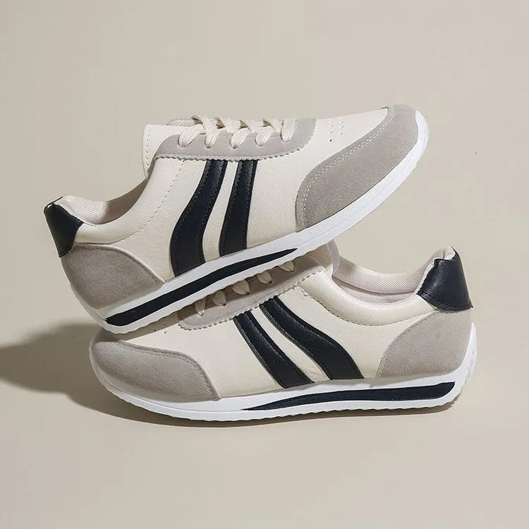 Red low-top lace-up running sneaker with round toe and rubber sole.