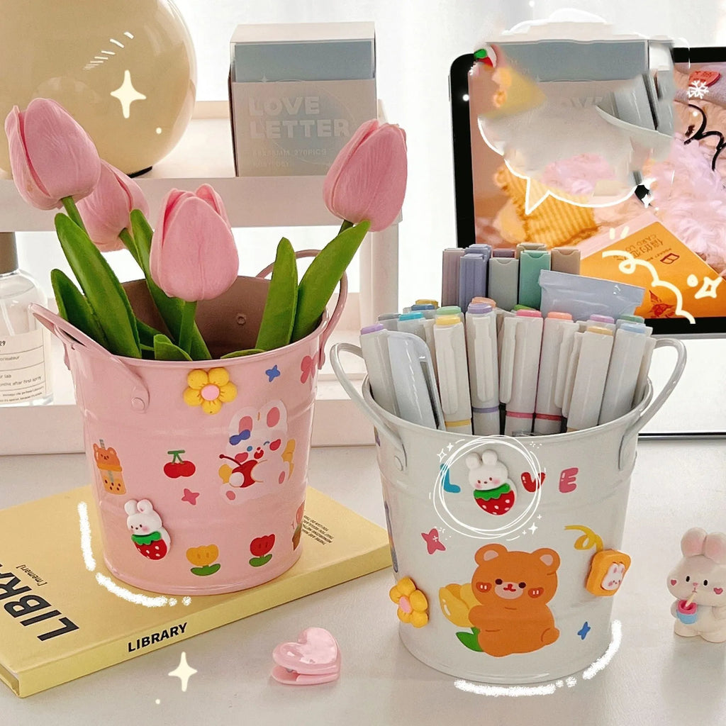 Round metal pen holder in green colour with decorative sticker patch design on desktop