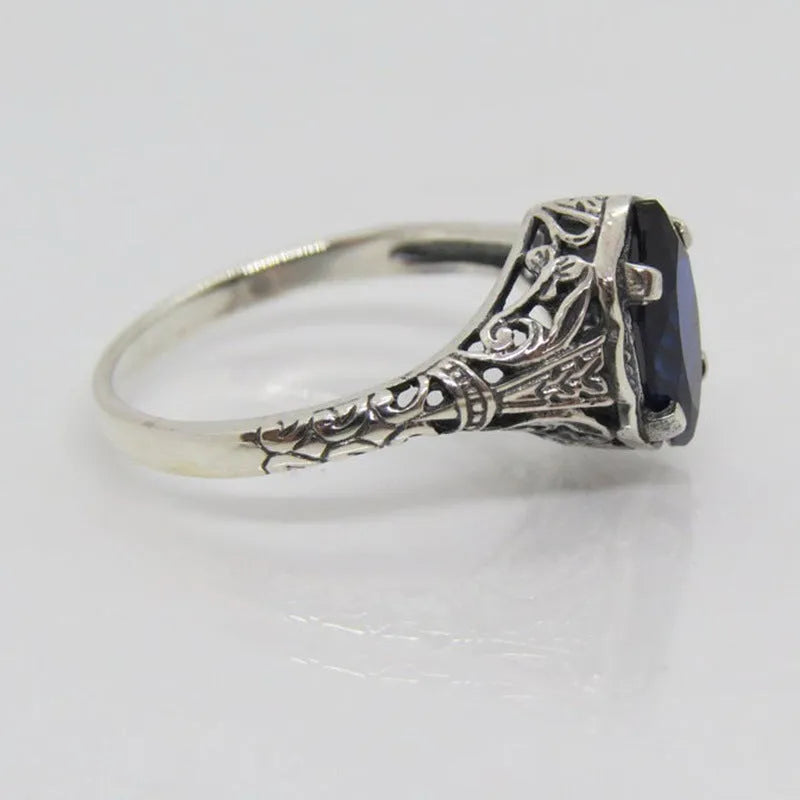 Women's geometric hollow ring in silver electroplated alloy with zircon detail showing open-work pattern