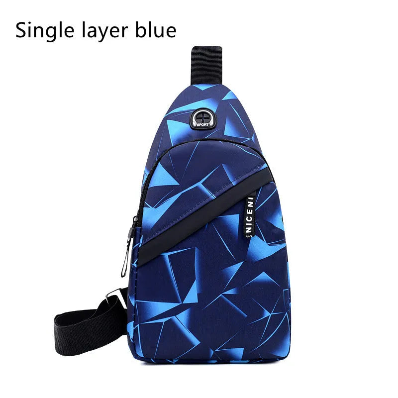 Men's blue Oxford cloth crossbody sling bag showing earphone hole and front zipper.